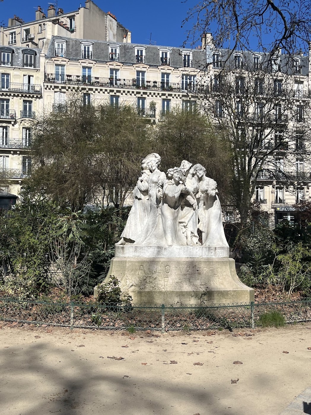 A statue within Square Montholon, Les statues des Catherinettes by Julien Lorieux, depicting four young women celebrating Saint Catherine’s Day.<br />